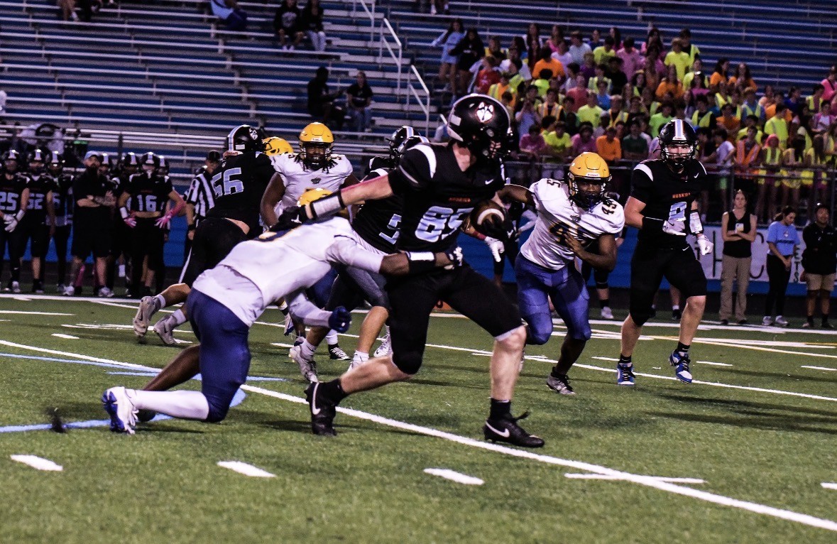 Charlie Grewe running on the football field